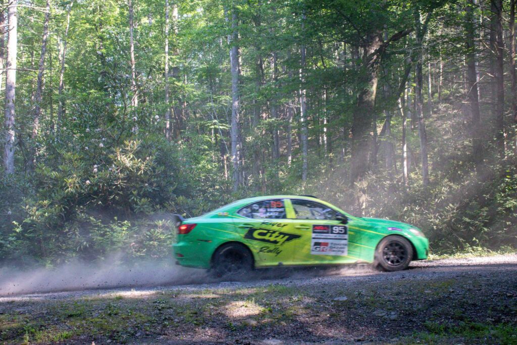 rally car racing through the woods