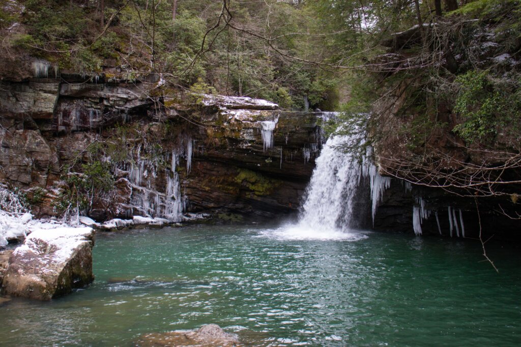 wide angle shot of savage falls showcasing the blue hole at the base of the falls